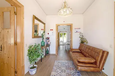 a living room with a brown leather couch at Villa Rodrigues Apartment I in Boliqueime