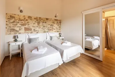a bedroom with two beds and a mirror at Villa Rodrigues in Boliqueime