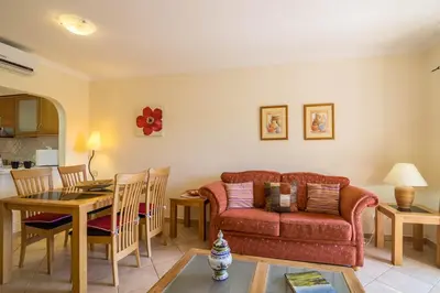 a kitchen and dining room with a table and chairs at Albufeira Apartment in Albufeira