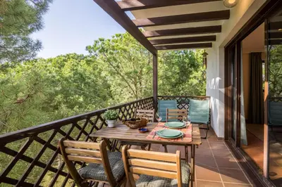 a patio with a table and chairs on a balcony at Falésia Pine Spot in Albufeira