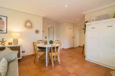 a kitchen and dining room with a table and chairs at Falésia Pine Spot in Albufeira