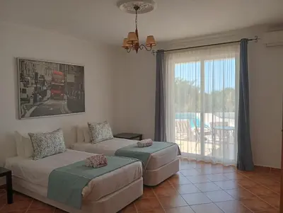 a living room with a couch and a window at Villa Núria in Loulé