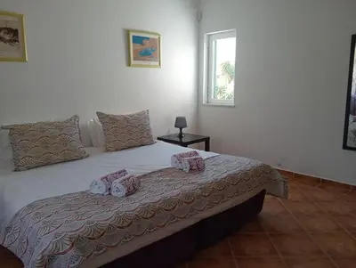 a bedroom with a bed with towels on it at Villa Núria in Loulé