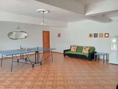 a living room with a table and a couch at Villa Núria in Loulé