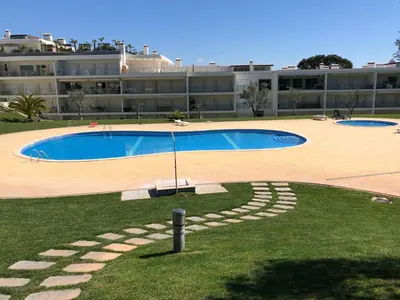 a large swimming pool in front of a building at Pinetops holidays Apartment in Albufeira