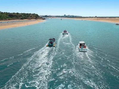 two boats in the water near a beach at Villa Grace Bay by Algarve Vacation in Guia