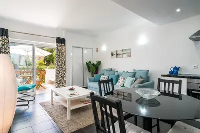 a living room with a table and a couch at Serenity by Intiholidays in Quarteira