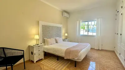 a bedroom with a white bed and a window at Abby by Check-in Portugal in Albufeira