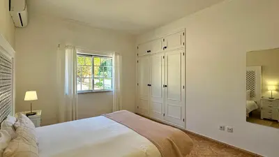 a white bedroom with a bed and a window at Abby by Check-in Portugal in Albufeira