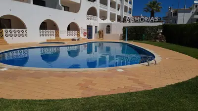 a swimming pool in front of a building at Alta Oura Prime by Sunny Deluxe in Albufeira