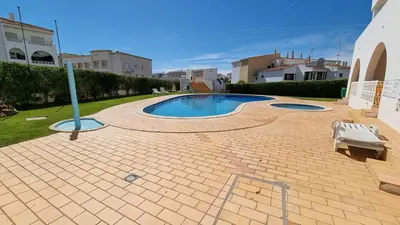 a swimming pool in a yard with a bench at Alta Oura Prime by Sunny Deluxe in Albufeira