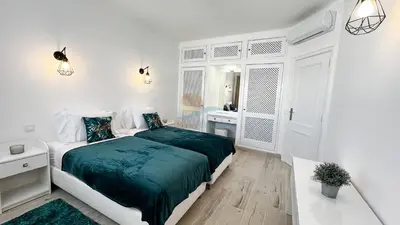 a white bedroom with a bed and a bathroom at Alta Oura Prime by Sunny Deluxe in Albufeira