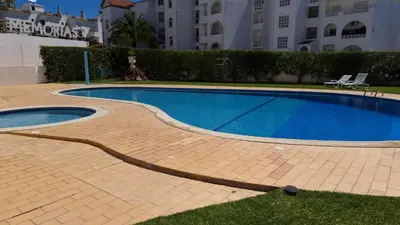a swimming pool in front of a building at Alta Oura Prime by Sunny Deluxe in Albufeira