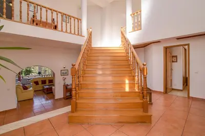 a staircase in a home with wooden steps at Villa do Lago in Albufeira