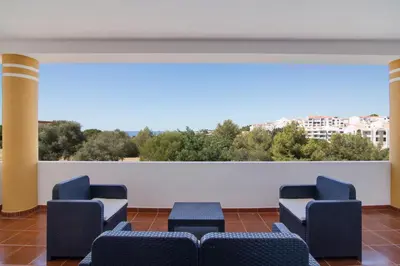 a waiting room with chairs and a large window at Villa do Lago in Albufeira