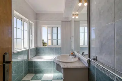 a bathroom with a sink and a shower and a tub at Villa do Lago in Albufeira