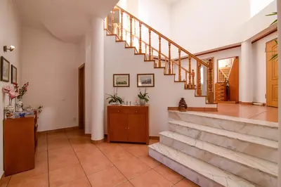 a hallway with a staircase in a house at Villa do Lago in Albufeira