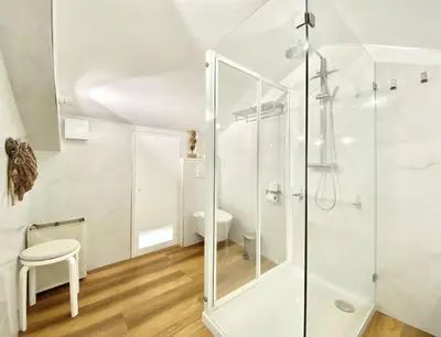 a bathroom with a glass shower stall and a toilet at Mira Marina - Vilamoura in Vilamoura