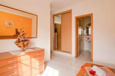 a kitchen with a dresser with a vase on it at Bosque São José Af in Albufeira