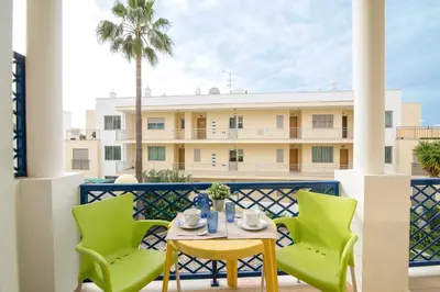 a balcony with a table and chairs and a building at Bosque São José Ag in Olhos de Água