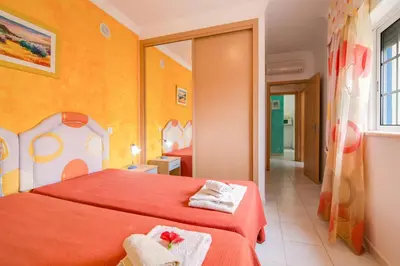 a bedroom with a red bed with two towels on it at Bosque São José Ag in Olhos de Água