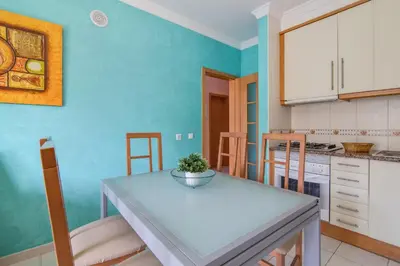 a kitchen with a table and chairs in a room at Bosque São José Ag in Olhos de Água