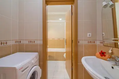 a bathroom with a sink and a washing machine at Bosque São José Ag in Olhos de Água