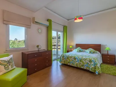 a bedroom with a bed and a chair at Holiday Home Bela Vitta by Interhome in Ferreiras