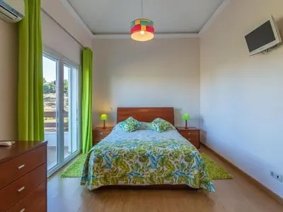a bedroom with a bed and a large window at Holiday Home Bela Vitta by Interhome in Ferreiras