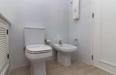 a white bathroom with a toilet and a sink at Blue Apartment Balaia Space - By Dalma Portuguesa in Albufeira