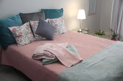 a bedroom with a bed with a towel on it at Ricardo Rolão Vista Mar - Edifício Oásis - Bedrooms in Faro