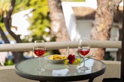 two glasses of wine and a bowl of food on a table at Apartment Victoria - Quinta do Lago in Quinta do Lago