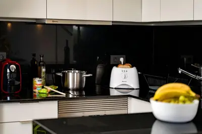 a kitchen counter with a toaster and a bowl of food at Apartment Victoria - Quinta do Lago in Quinta do Lago