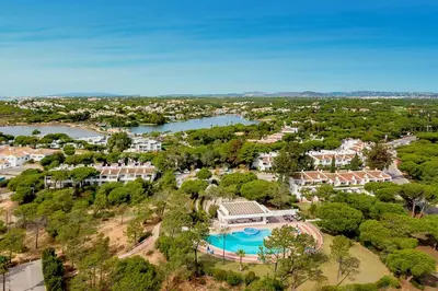 an aerial view of a resort with a pool and trees at Apartment Victoria - Quinta do Lago in Quinta do Lago