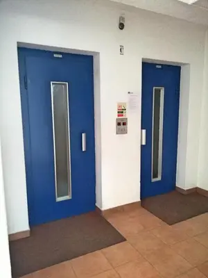 two blue doors in a room with mirrors at Praia Mar in Quarteira