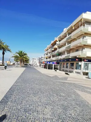 a cobblestone street in front of a building at Praia Mar in Quarteira
