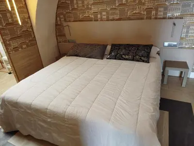 a bedroom with a large bed in a room at São Pedro Suite Faro in Faro