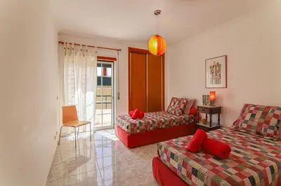 a living room with a couch and a chair at Casa do Algarve in Albufeira