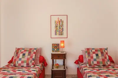 a room with two beds and a table with a lamp at Casa do Algarve in Albufeira