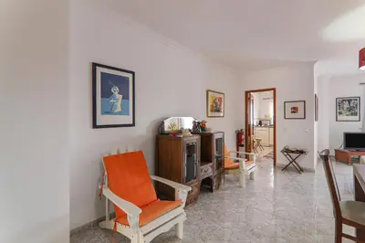 a living room with two chairs and a television at Casa do Algarve in Albufeira