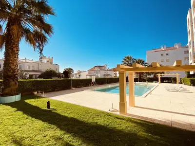 a swimming pool in a yard with a palm tree at Vista by Check-in Portugal in Albufeira