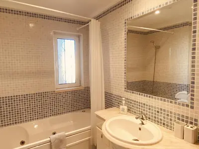 a bathroom with a sink and a tub and a toilet at Vista by Check-in Portugal in Albufeira