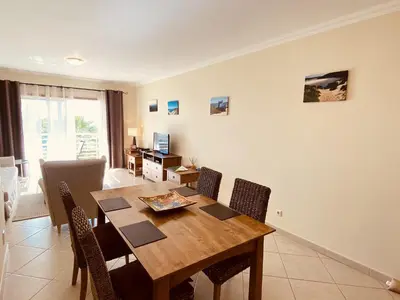 a dining room with a wooden table and chairs at Vista by Check-in Portugal in Albufeira