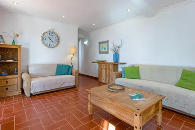 a living room with a couch and a coffee table at Casa Mimao in Albufeira