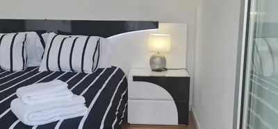 a bedroom with a bed with a lamp and towels at Villa Modern Design in Albufeira