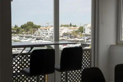 a view of a marina from a window with chairs at Marina Pearl - View to Vilamoura Marina in Vilamoura