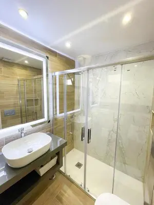 a bathroom with a sink and a glass shower at Apartamentos SweetHomes in Faro