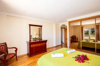 a bedroom with a bed and a mirror and a bed at Villa Samoa by Algarve Vacation in Albufeira