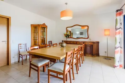 a dining room with a wooden table and chairs at Villa Protea - 5 bedroom, beach, air-con, wifi in Albufeira