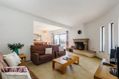 a living room with two couches and a fireplace at Villa Protea - 5 bedroom, beach, air-con, wifi in Albufeira